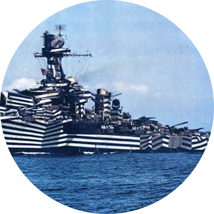 A warship painted in dazzle camouflage, magnified on the hard bands running across its hull